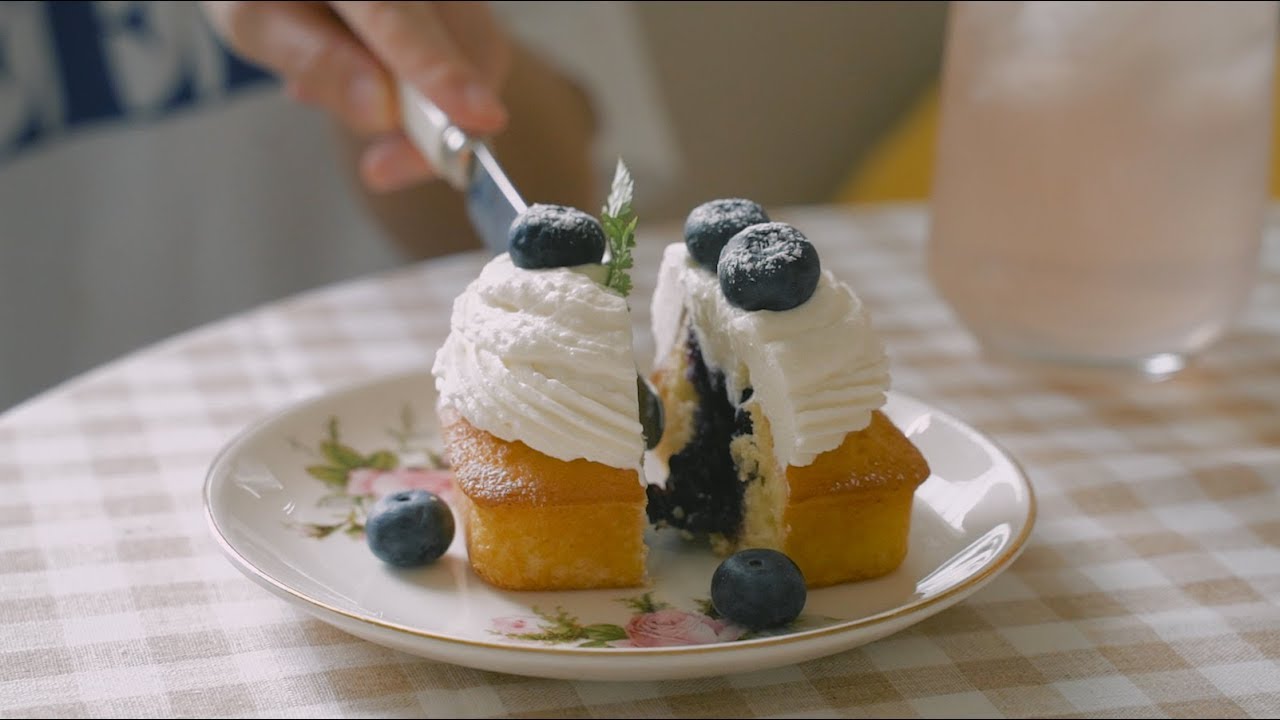 blueberry compote pound cake on a plate being cut open